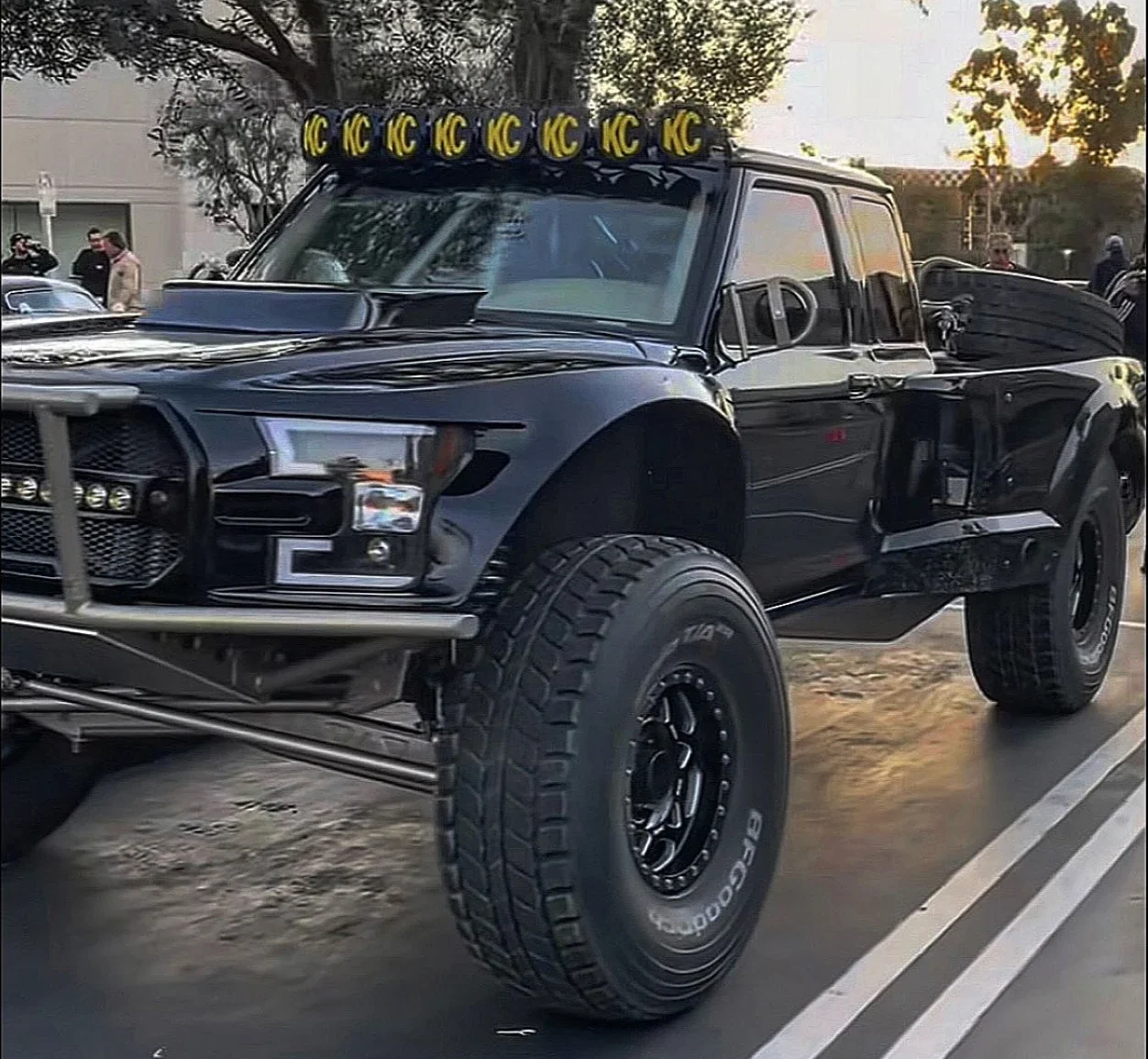 Black prerunner truck with roof light bar on the street