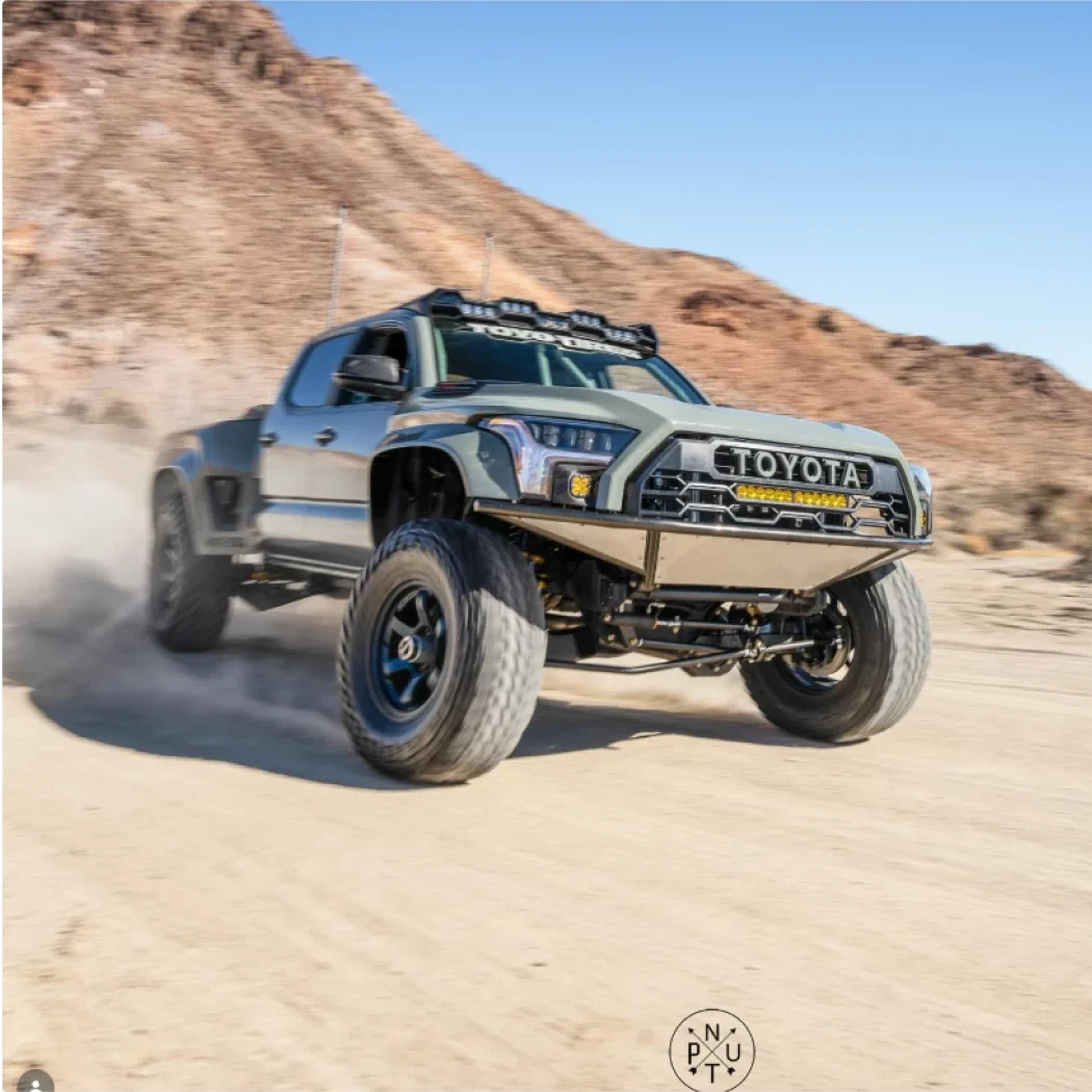 Prerunner Tacoma sliding through desert sand